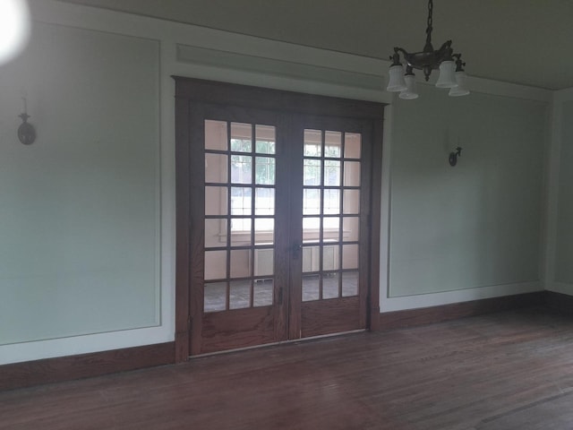516 S Grant St, Earlville, IL 60518 - unfurnished dining area featuring a chandelier, wood finished floors, and french doors