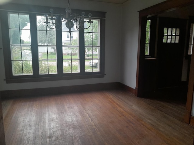 516 S Grant St, Earlville, IL 60518 - unfurnished dining area featuring a chandelier and wood finished floors