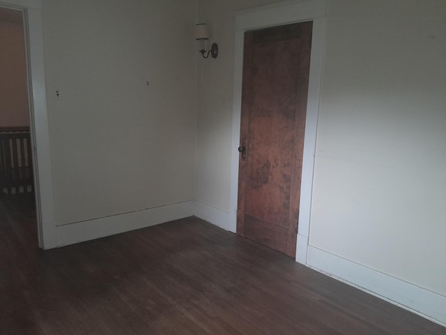 516 S Grant St, Earlville, IL 60518 - empty room with dark wood-style flooring