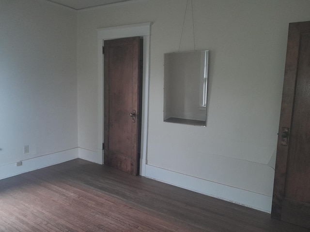 516 S Grant St, Earlville, IL 60518 - spare room with dark wood-style floors and baseboards