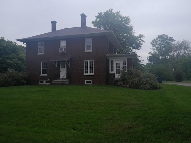 516 S Grant St, Earlville, IL 60518 - rear view of house with a chimney, a yard, brick siding, and entry steps