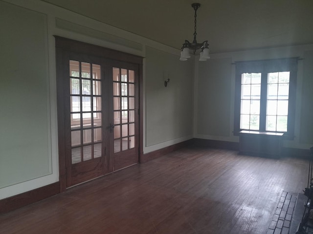 516 S Grant St, Earlville, IL 60518 - unfurnished dining area featuring a chandelier, french doors, and dark wood-style floors