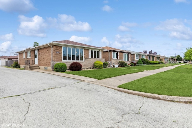 12746 S Marquette Ave, Chicago, IL 60633 - view of front of property featuring brick siding, a front lawn, and a residential view