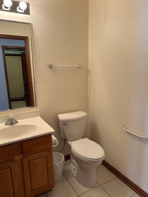 13804 Ironwood Dr, Plainfield, IL 60544 - half bath with vanity, tile patterned floors, toilet, and baseboards