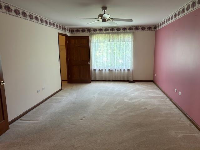 13804 Ironwood Dr, Plainfield, IL 60544 - spare room with light carpet, a ceiling fan, and baseboards