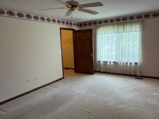 13804 Ironwood Dr, Plainfield, IL 60544 - unfurnished room featuring a ceiling fan, light colored carpet, and baseboards