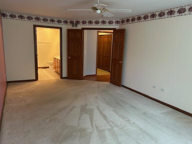 13804 Ironwood Dr, Plainfield, IL 60544 - spare room with light colored carpet, a ceiling fan, and baseboards