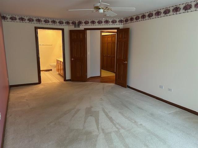 13804 Ironwood Dr, Plainfield, IL 60544 - unfurnished bedroom featuring light carpet, baseboards, ensuite bath, and ceiling fan