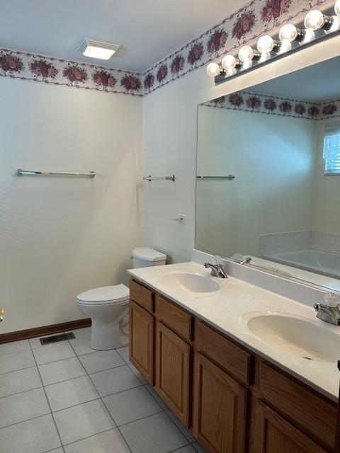 13804 Ironwood Dr, Plainfield, IL 60544 - full bathroom with a bath, double vanity, tile patterned floors, and toilet