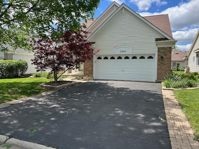 13804 Ironwood Dr, Plainfield, IL 60544 - view of front of home with driveway, brick siding, and a garage