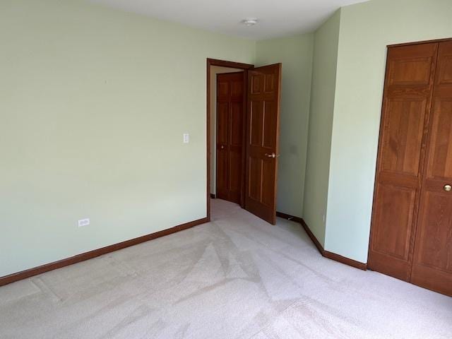 13804 Ironwood Dr, Plainfield, IL 60544 - unfurnished bedroom with light carpet, baseboards, and a closet