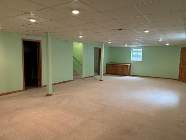 13804 Ironwood Dr, Plainfield, IL 60544 - basement featuring baseboards, stairs, light carpet, a drop ceiling, and recessed lighting