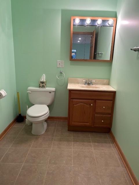 13804 Ironwood Dr, Plainfield, IL 60544 - bathroom with vanity, toilet, baseboards, and tile patterned floors