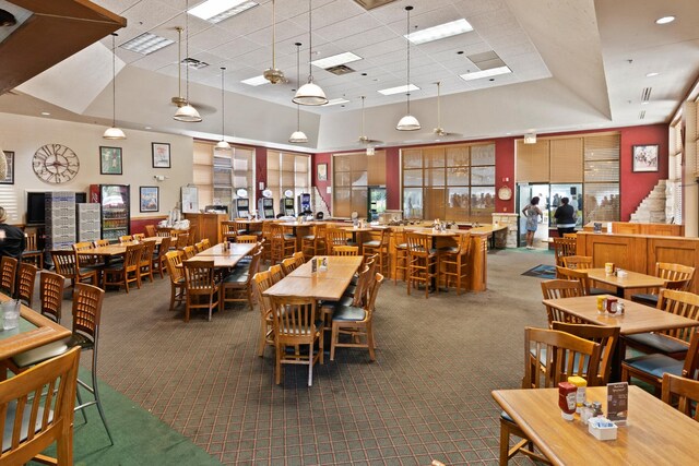 13804 Ironwood Dr, Plainfield, IL 60544 - dining area with dark carpet, a drop ceiling, and a towering ceiling