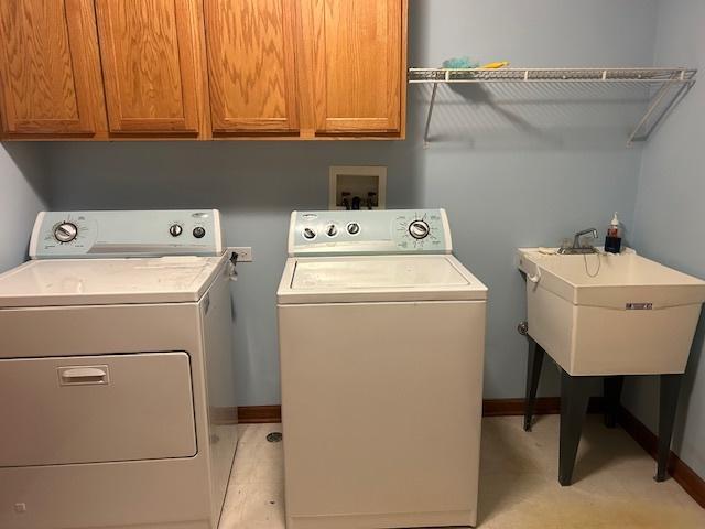 13804 Ironwood Dr, Plainfield, IL 60544 - washroom with separate washer and dryer, cabinet space, and baseboards