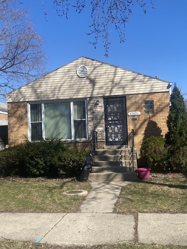 view of front of house featuring brick siding