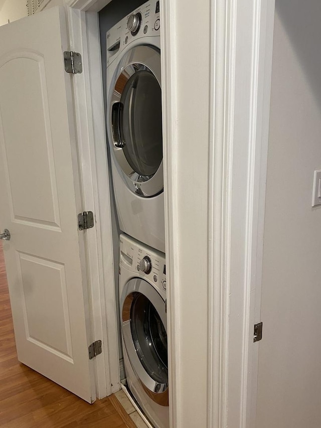 6643 W Belmont Ave Unit 1, Chicago, IL 60634 - laundry room with stacked washing machine and dryer and light wood-type flooring