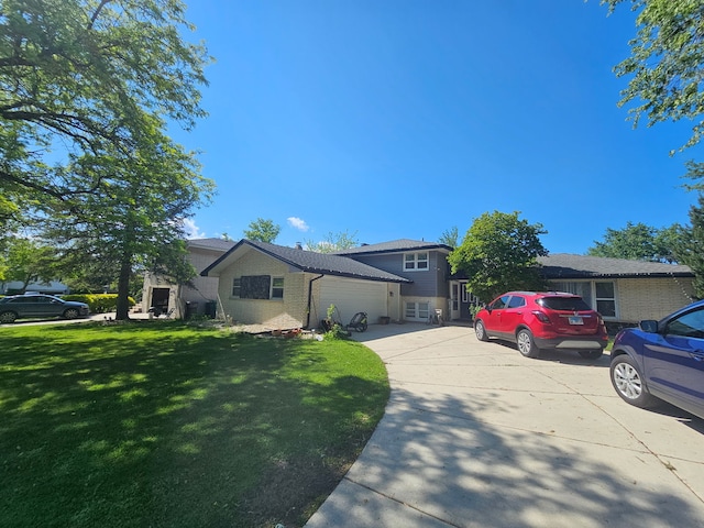 8554 Fir St, Orland Park, IL 60462 - split level home featuring a garage, driveway, a front lawn, and brick siding