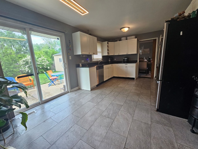 8554 Fir St, Orland Park, IL 60462 - kitchen with stainless steel appliances, white cabinets, a sink, and dark countertops