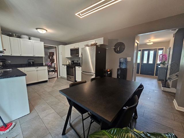 8554 Fir St, Orland Park, IL 60462 - kitchen with appliances with stainless steel finishes, white cabinetry, dark countertops, and a sink
