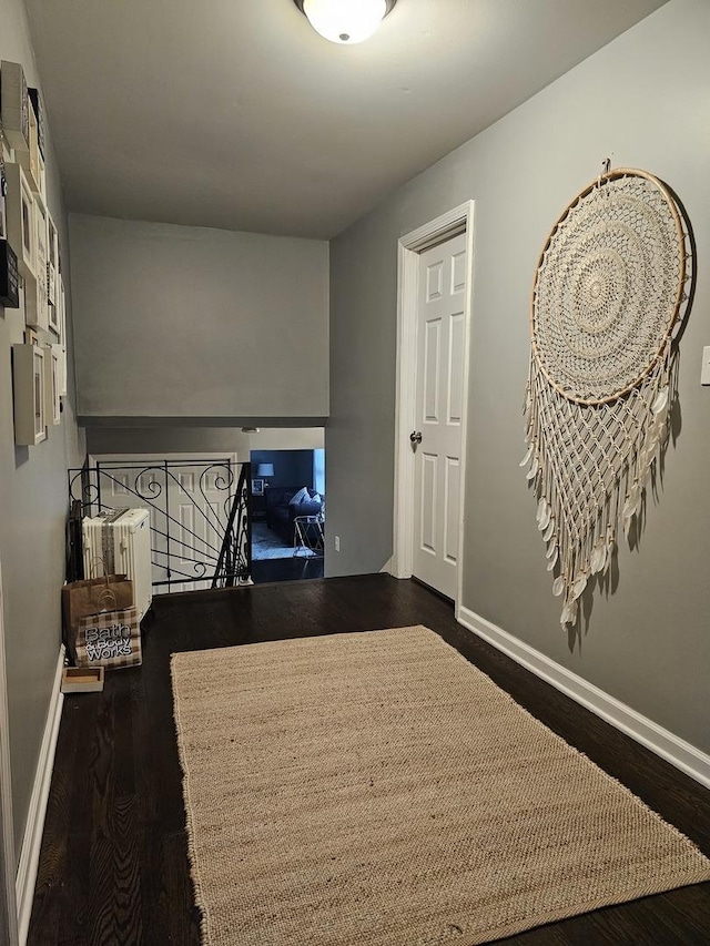 8554 Fir St, Orland Park, IL 60462 - hallway featuring dark wood-style floors, an upstairs landing, and baseboards