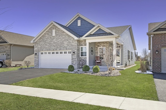 27363 W Macura St, Channahon, IL 60410 - view of front of property featuring asphalt driveway, a garage, a front lawn, and covered porch