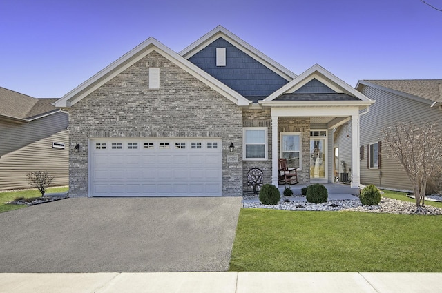 27363 W Macura St, Channahon, IL 60410 - view of front of home with asphalt driveway, a front yard, covered porch, and brick siding