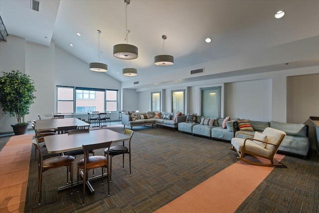 dining room featuring dark carpet, high vaulted ceiling, and recessed lighting