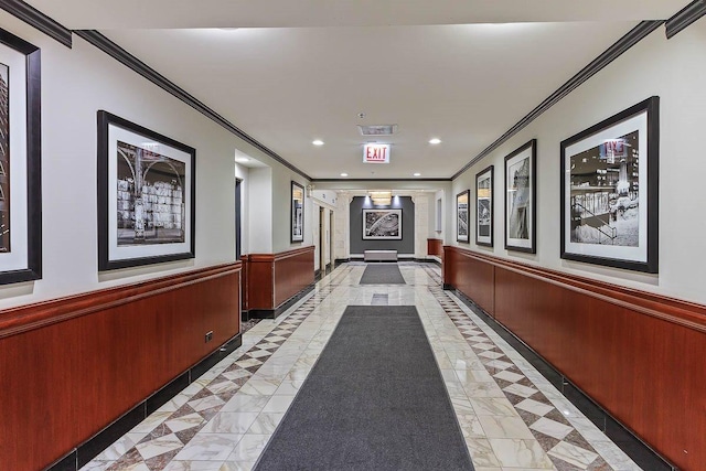 hall featuring ornamental molding, inlaid floor details, recessed lighting, and a wainscoted wall
