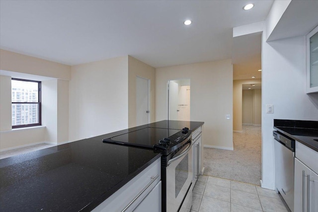 kitchen with stainless steel appliances, glass insert cabinets, light carpet, white cabinetry, and recessed lighting