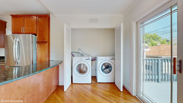 2636 W Grand Ave, Chicago, IL 60612 - laundry room with washing machine and dryer, light wood-type flooring, ornamental molding, and baseboards