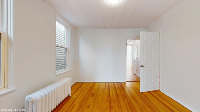 2636 W Grand Ave, Chicago, IL 60612 - unfurnished room featuring radiator heating unit, light wood-type flooring, and baseboards