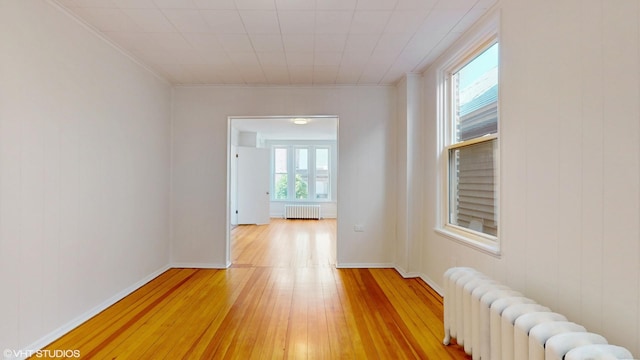 2636 W Grand Ave, Chicago, IL 60612 - hall with radiator, light wood-style flooring, crown molding, and baseboards