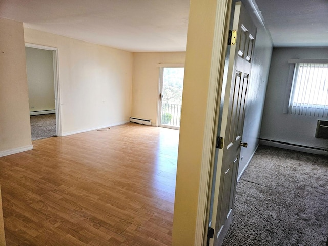 8928 Steven Dr Unit 2F, Des Plaines, IL 60016 - unfurnished room with a baseboard heating unit, healthy amount of natural light, and wood finished floors