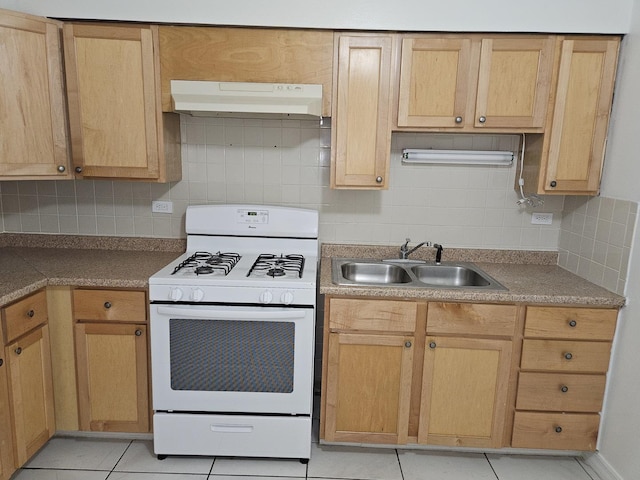 8928 Steven Dr Unit 2F, Des Plaines, IL 60016 - kitchen featuring a sink, white gas range oven, under cabinet range hood, backsplash, and light tile patterned floors