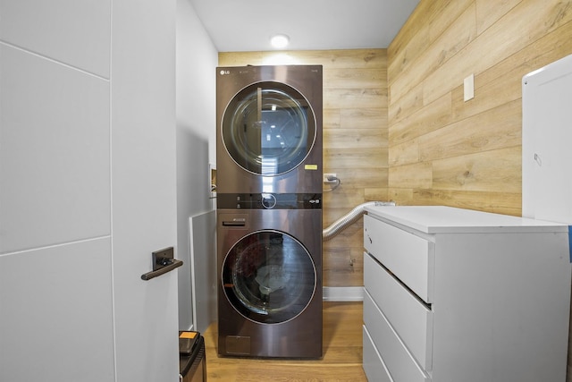 1184 Princeton Dr, Bartlett, IL 60103 - laundry room with stacked washer / drying machine, wooden walls, and light wood-type flooring