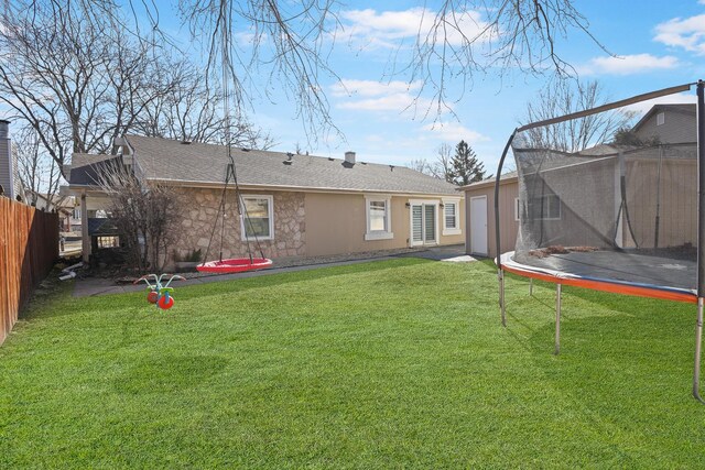 1184 Princeton Dr, Bartlett, IL 60103 - back of house featuring a trampoline and stone siding