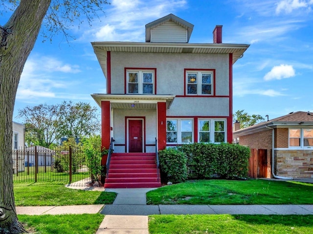american foursquare style home with a chimney and stucco siding