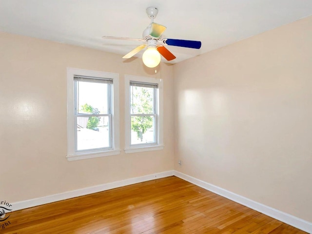 unfurnished room featuring baseboards, light wood finished floors, and a ceiling fan