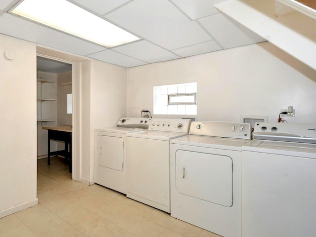 clothes washing area with washer and clothes dryer