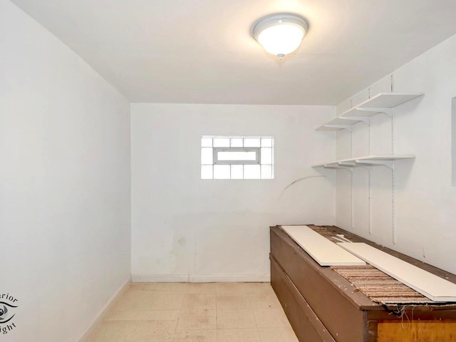 laundry area featuring baseboards