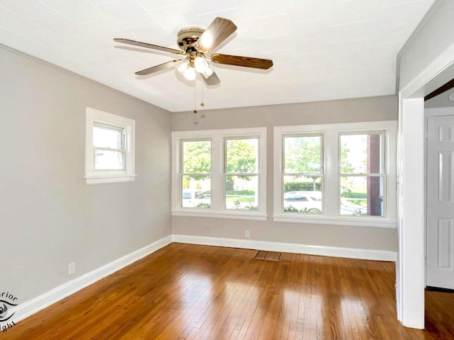 unfurnished room featuring baseboards, wood-type flooring, and ceiling fan
