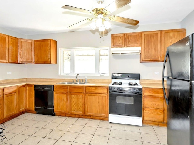 kitchen featuring black appliances, a sink, under cabinet range hood, and light countertops