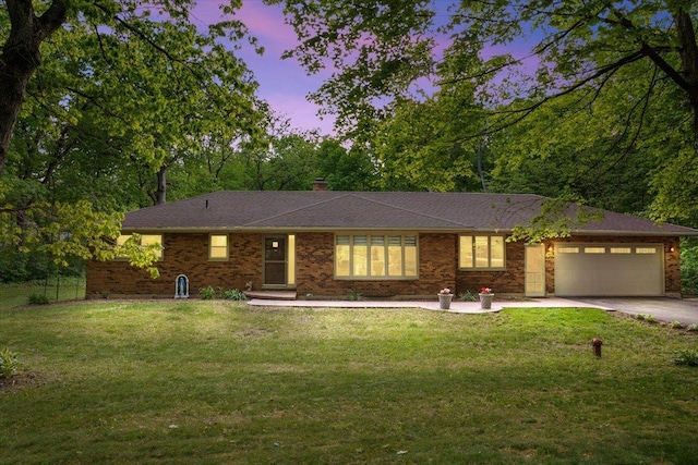 7417 N Hill Rd, Marengo, IL 60152 - ranch-style home featuring an attached garage, driveway, a front lawn, and brick siding