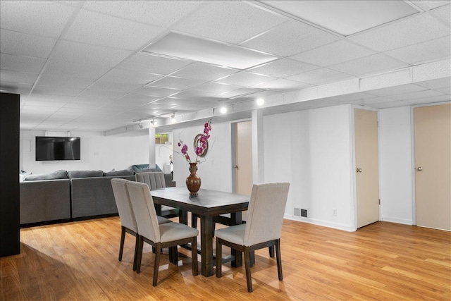 7417 N Hill Rd, Marengo, IL 60152 - dining area featuring light wood-style flooring, a drop ceiling, and baseboards