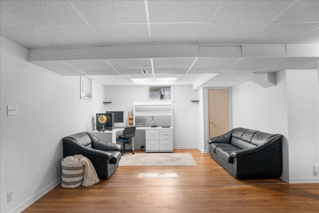 7417 N Hill Rd, Marengo, IL 60152 - living room with an office area, light wood-type flooring, a drop ceiling, and baseboards