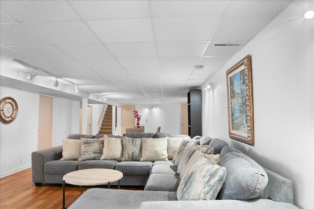 7417 N Hill Rd, Marengo, IL 60152 - living room with wood finished floors, stairway, a drop ceiling, and baseboards