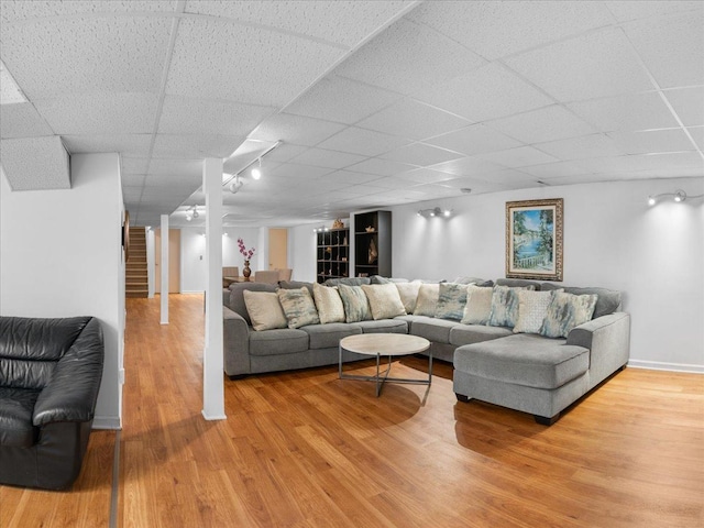 7417 N Hill Rd, Marengo, IL 60152 - living room featuring a drop ceiling, wood finished floors, and stairway