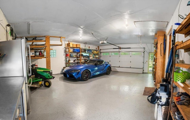 7417 N Hill Rd, Marengo, IL 60152 - garage featuring freestanding refrigerator and a garage door opener