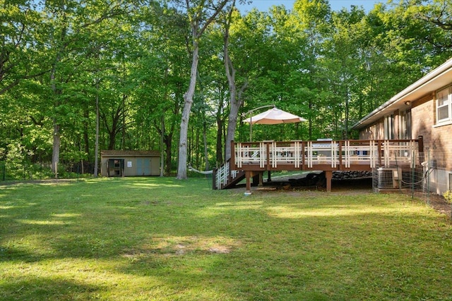7417 N Hill Rd, Marengo, IL 60152 - view of grassy yard with a wooden deck, stairs, central AC unit, and view of wooded area